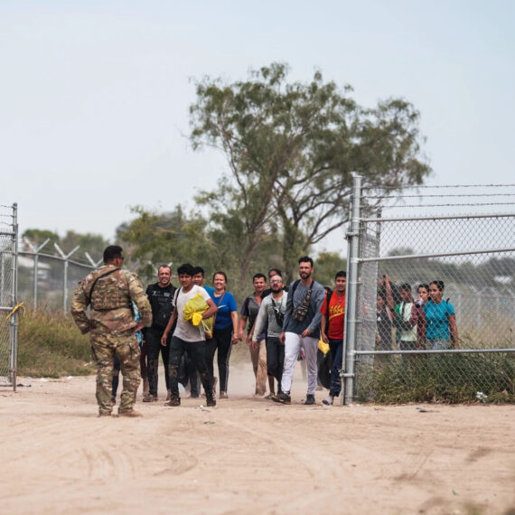 A Texas National Guard officer leads a group of migrants to be processed by U.S. Border Patrol after crossing the U.S. southern border with Mexico on Oct. 9, 2022 in Eagle Pass, Texas.Allison Dinner / AFP via Getty Images file